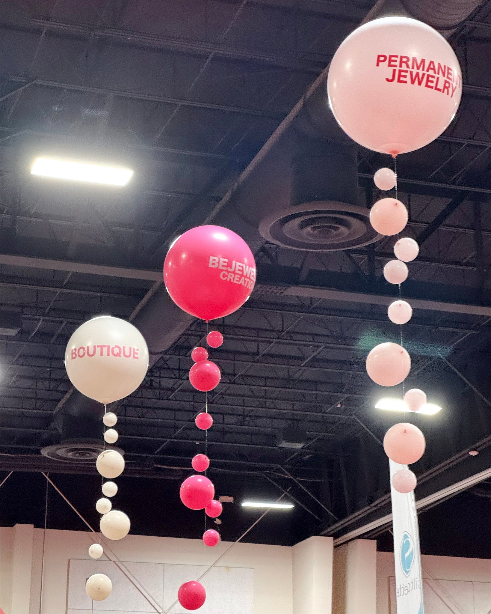 Balloons with 'Permanent Jewelry' and 'Boutique' float at Pinners Conference in Utah to mark vendor booth for Bejeweled Creations
