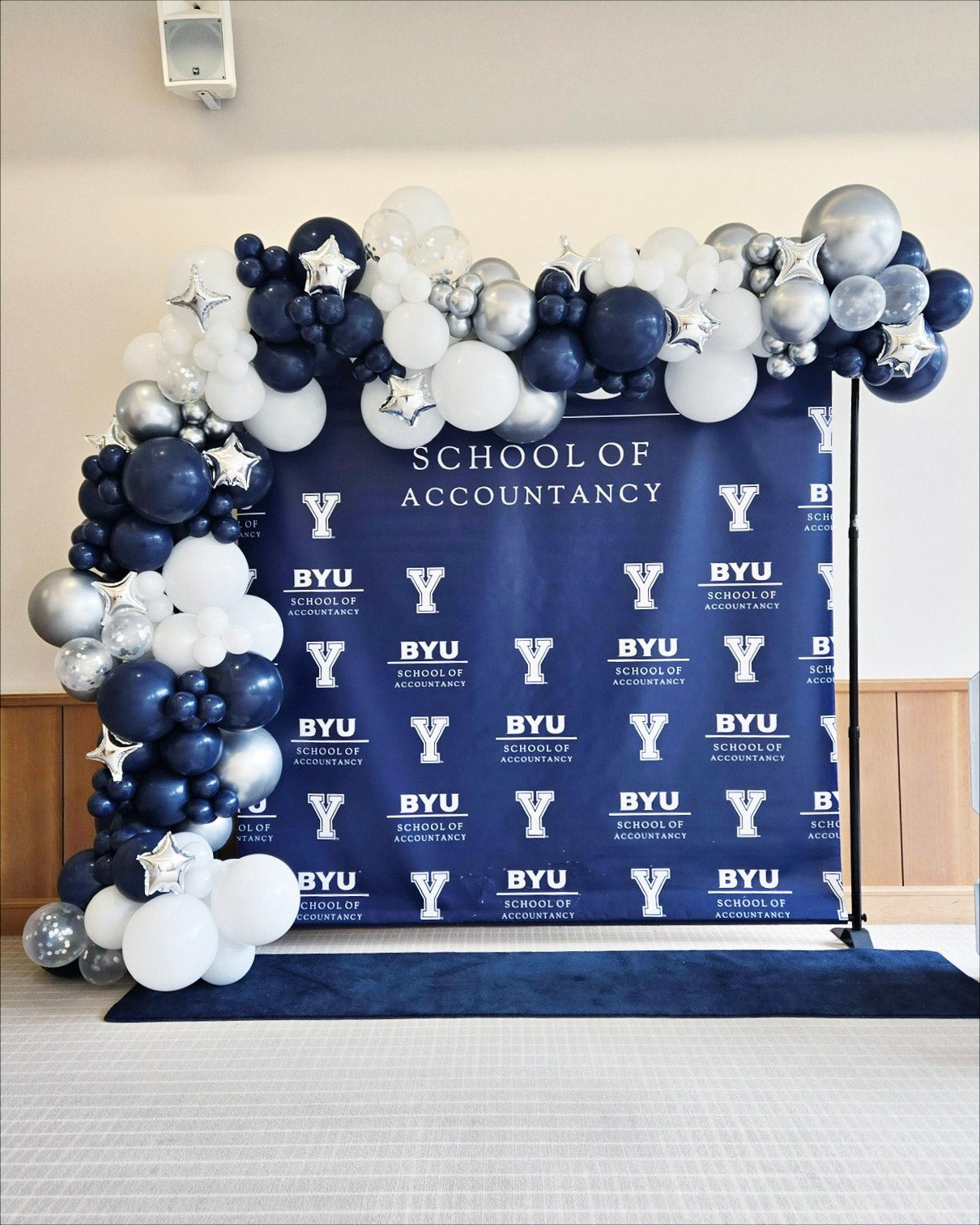 Balloons framing backdrop at BYU graduation.