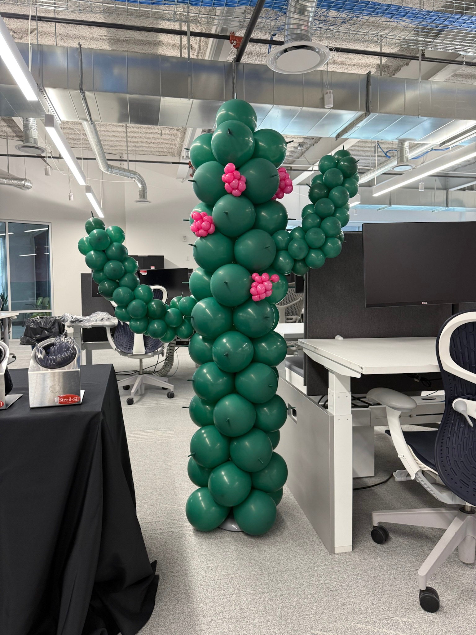 Balloon cactus sculpture in an office setting