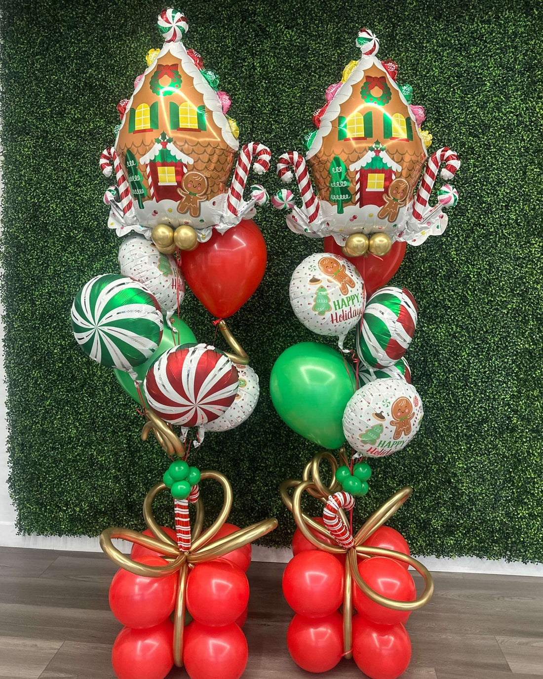 Pair of gingerbread-themed Christmas helium balloon bouquets with red, green, and gold helium balloons, created by Utah Balloon Creations for delivery