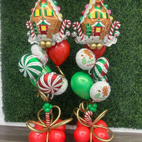 Pair of gingerbread-themed Christmas helium balloon bouquets with red, green, and gold helium balloons, created by Utah Balloon Creations for delivery