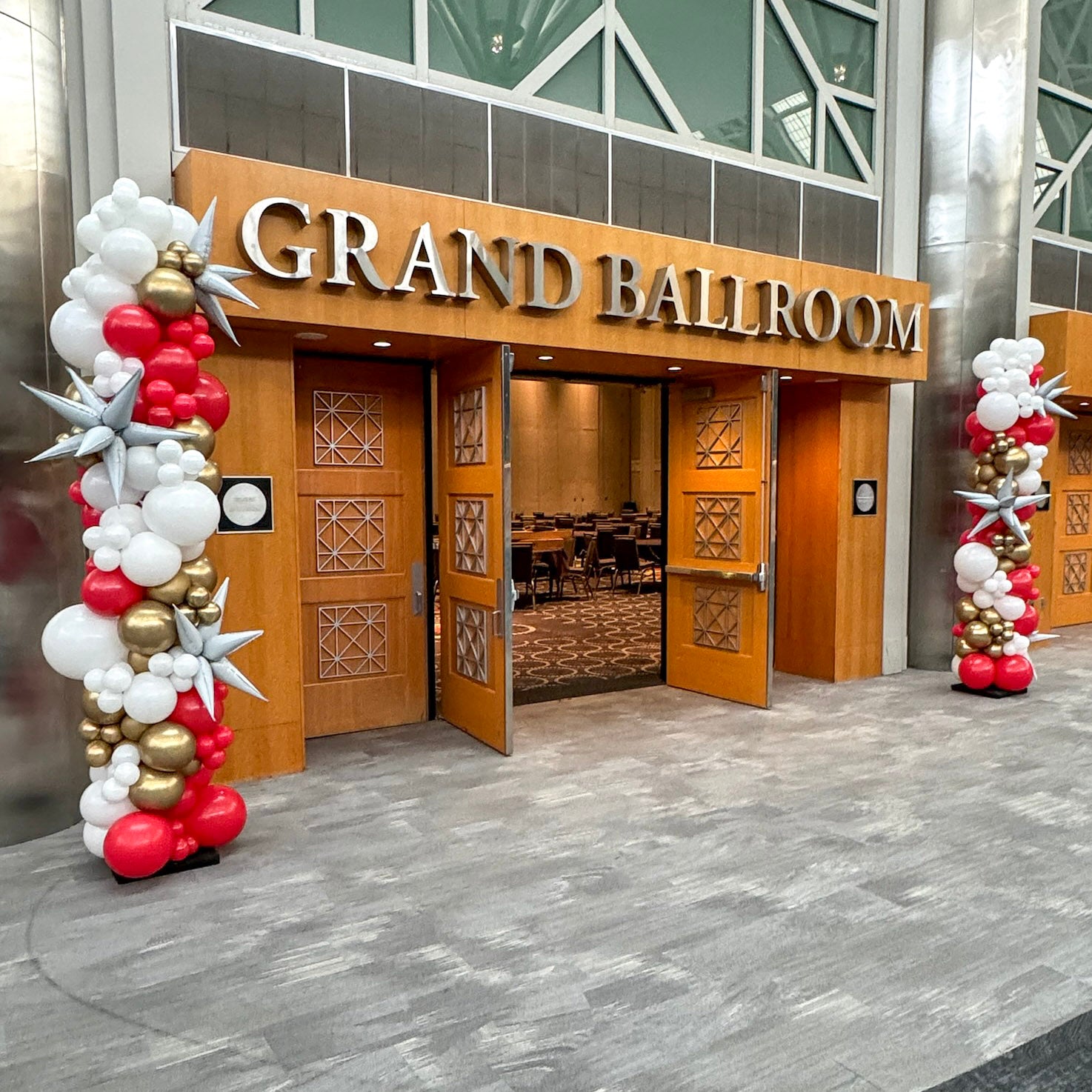 red, white, gold balloon columns mark entrance to a corporate conference in salt lake city Salt Palace