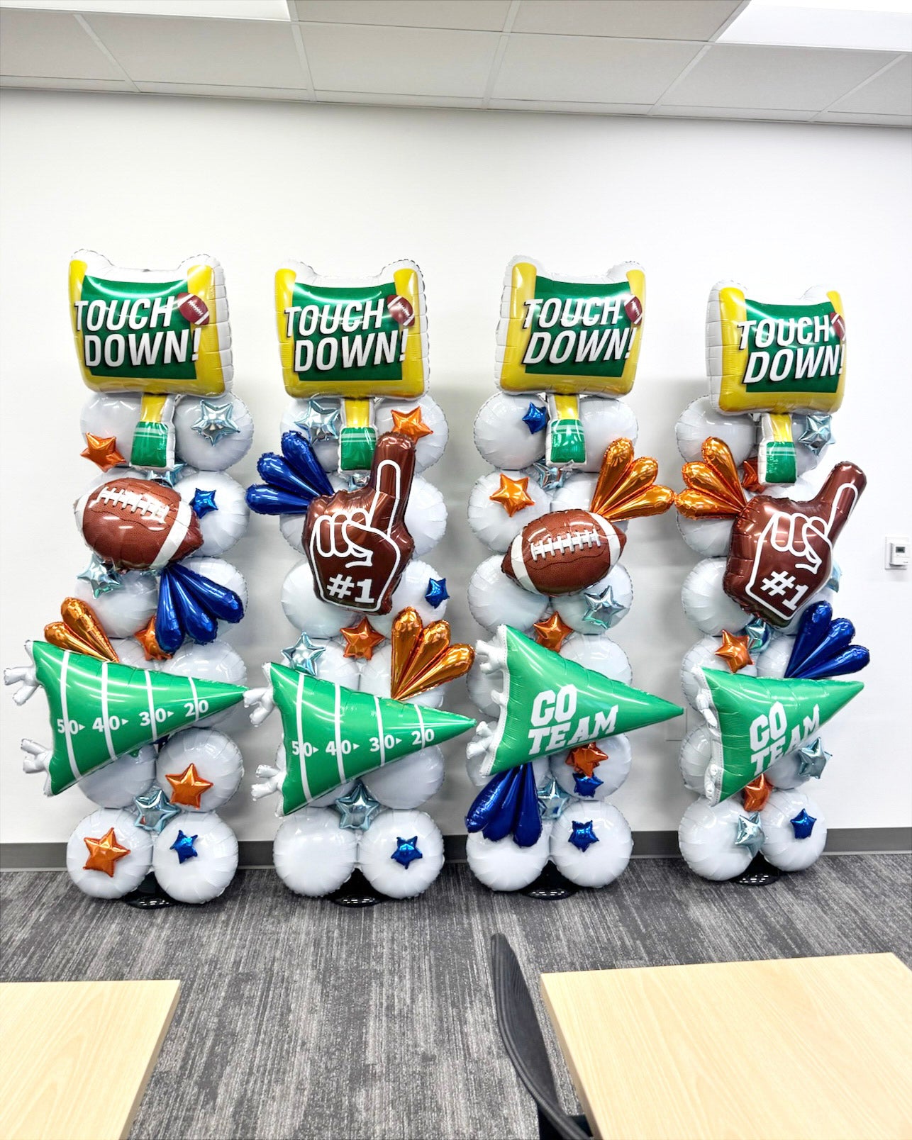 Football themed balloon columns at headquarters for "Friday Night Light" themed event