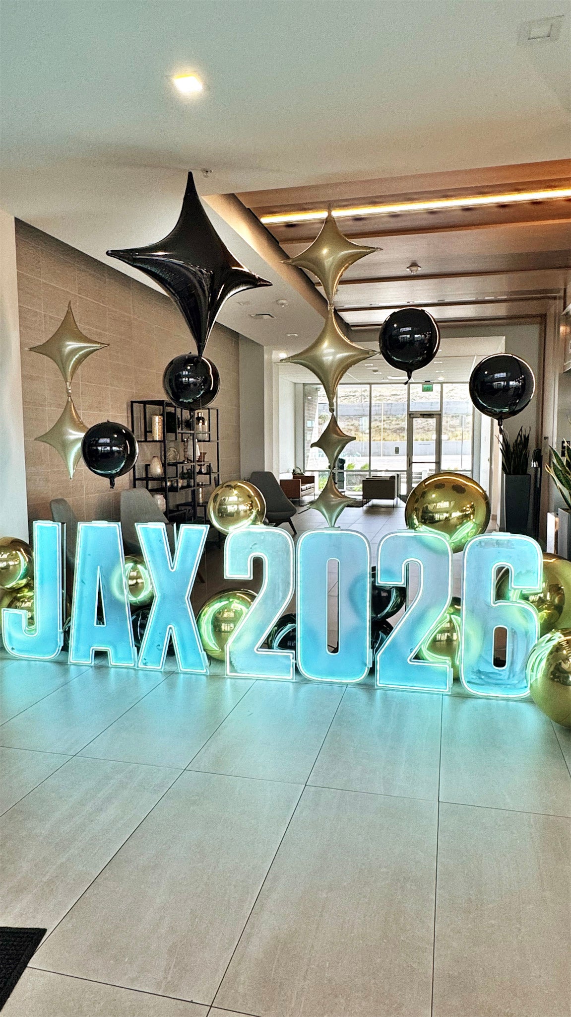 LED Letter Marquee display with floating orb balloons in an office space