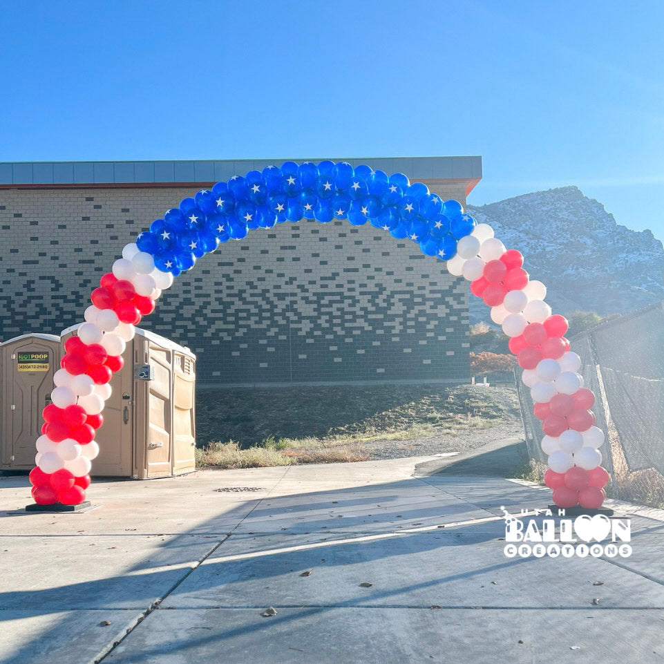 American flag balloon arch frames outdoor entrance to celebration