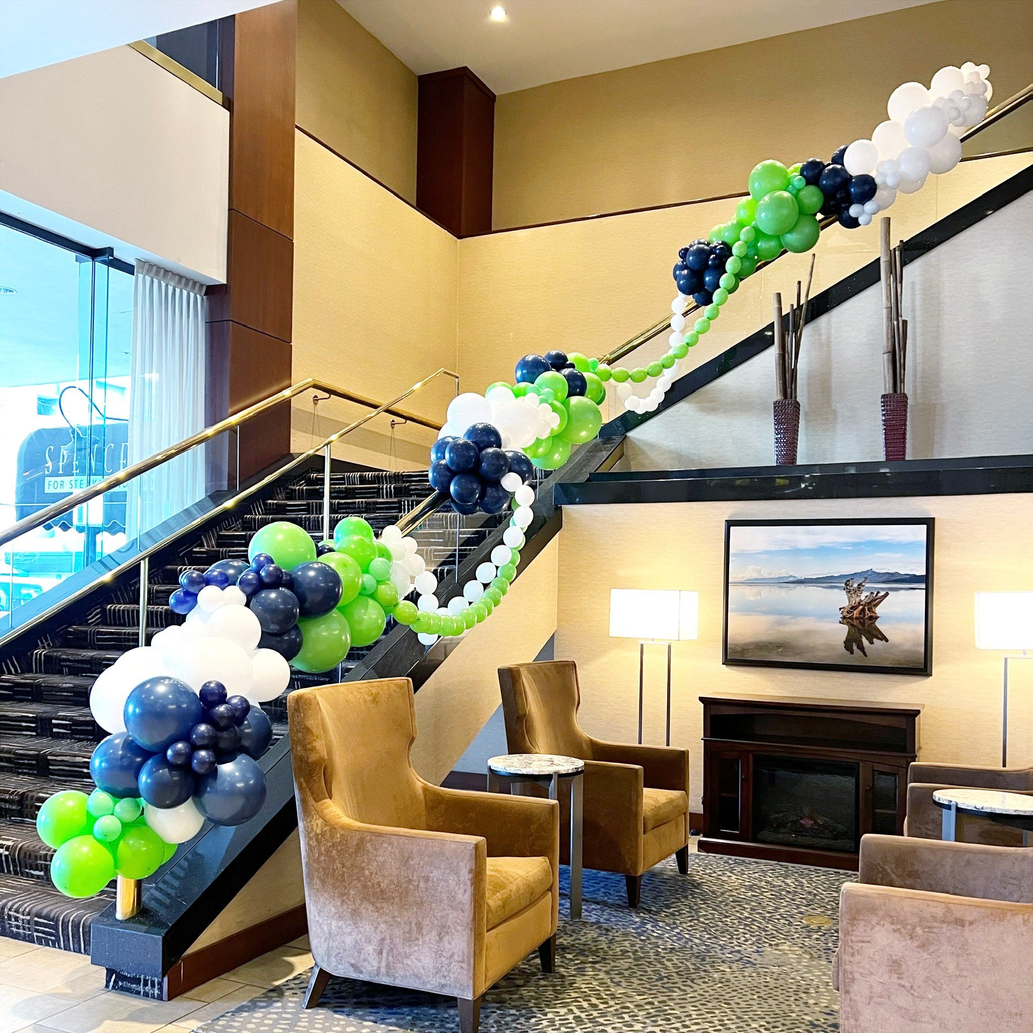 Decorative balloon garland ascends staircase at a corporate conferences at the Hilton in Salt Lake City