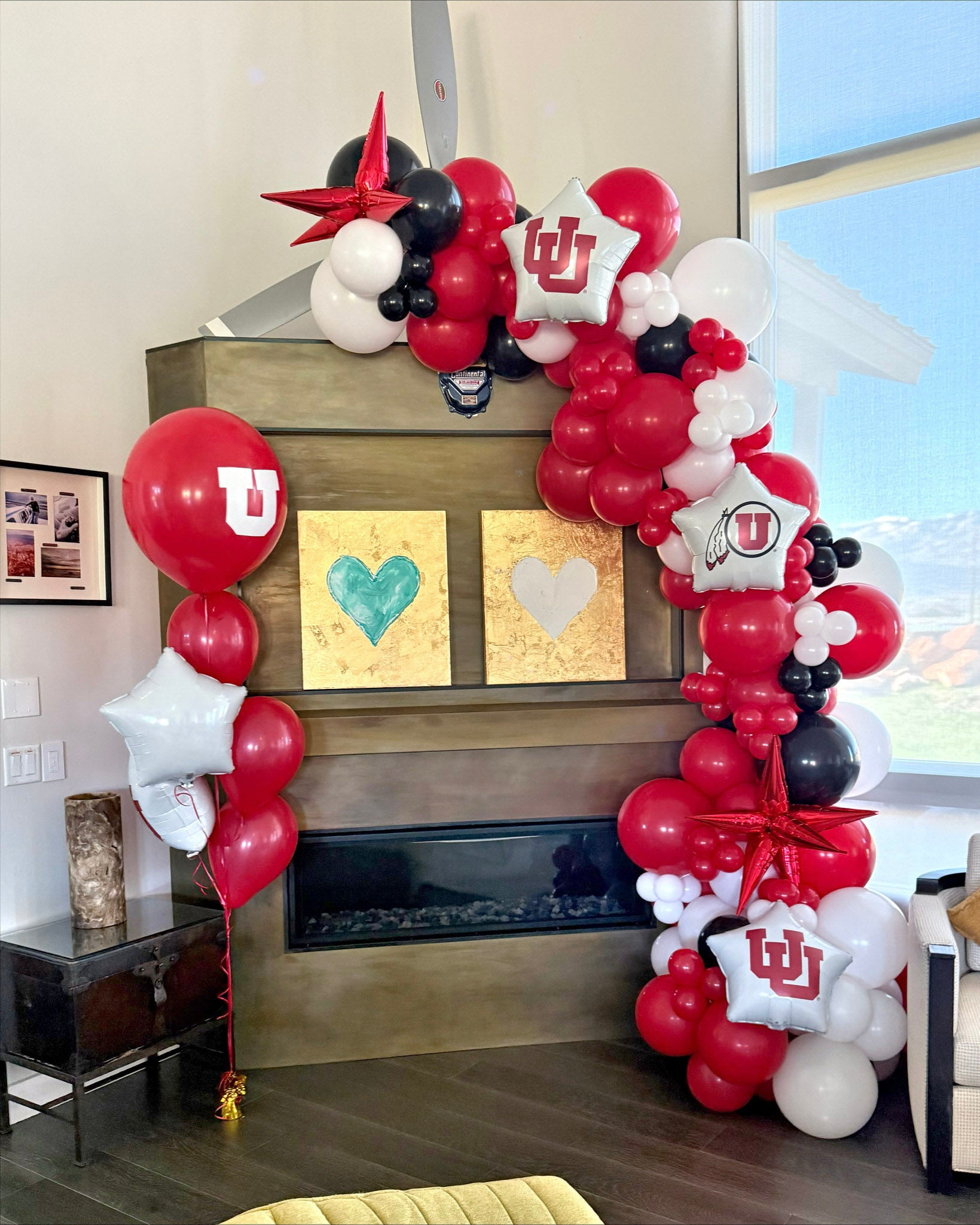 Decorative balloon arch with red, white, and black balloons in a room to celebrate graduation from University of Utah, Salt Lake City.